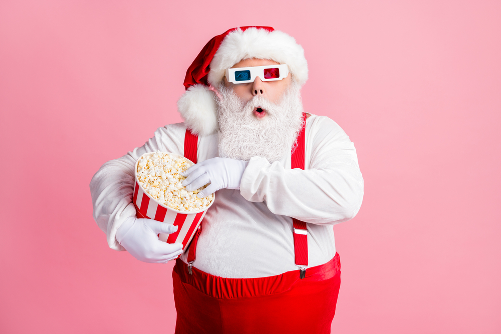 Santa watching film eating fast fastfood corn spending free time pastime isolated pink pastel color background